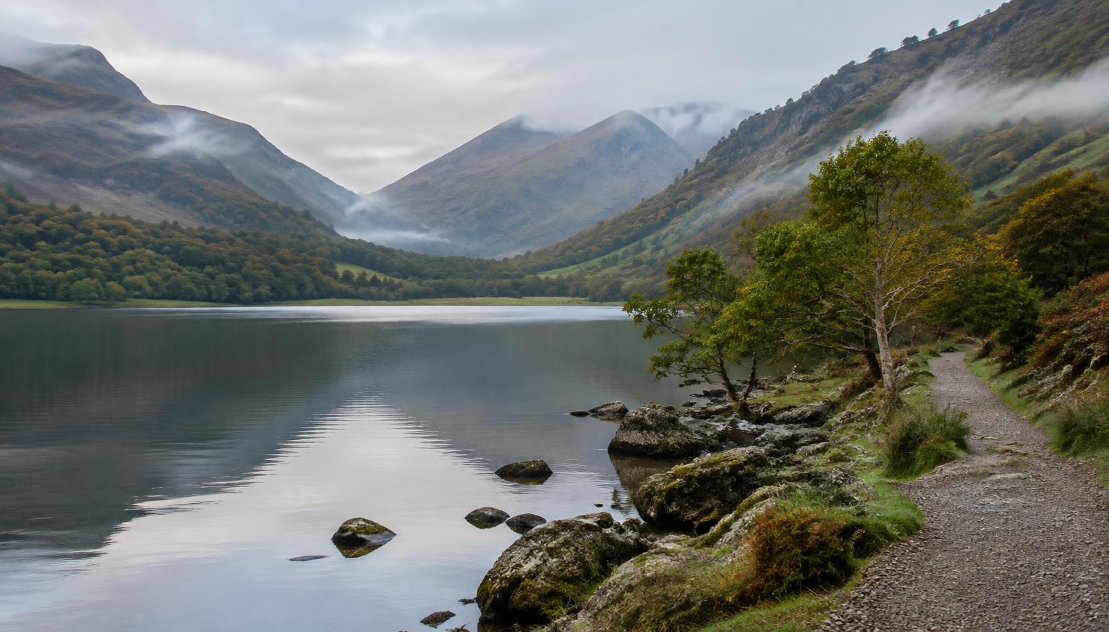 Lakeside path along Ennerdale Water with misty fells